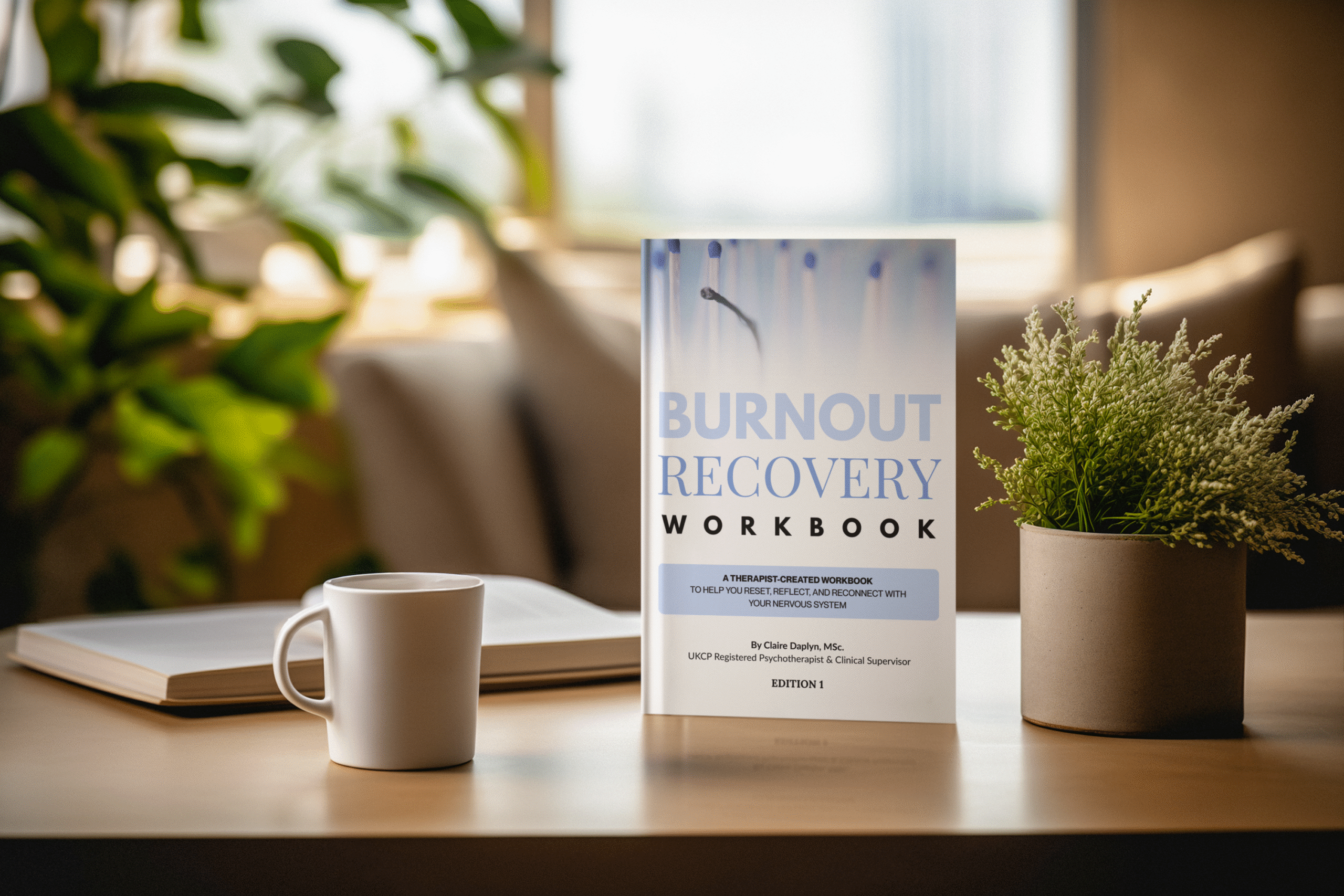 Book beside plant and mug